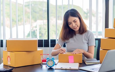 Small business owners wear many hats, including compliance with state data privacy laws Small business owner filling orders by packing boxes